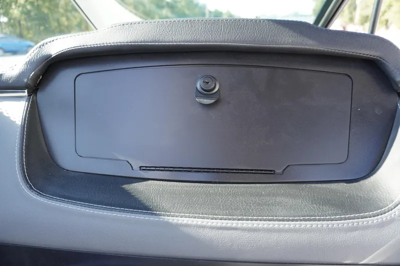Slide: The Image of Dashboard compartment of 2026 Chaparral 247 SSX boat, featuring sleek black design. - 25
