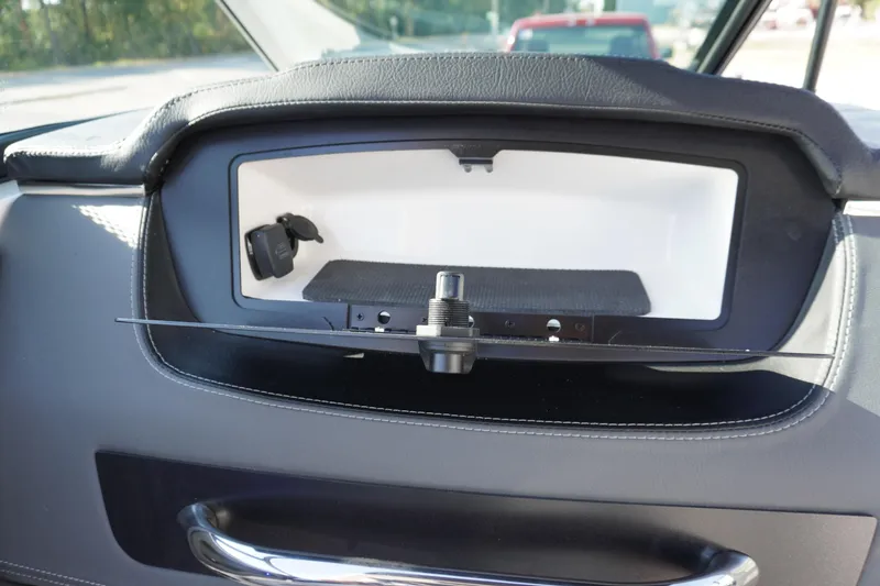 Slide: The Image of Dashboard compartment of 2026 Chaparral 247 SSX boat, featuring sleek design and storage space. - 26