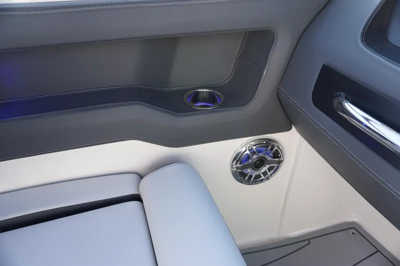 Slide: The Image of Interior of 2026 Chaparral 247 SSX boat, featuring sleek seating and built-in speaker. - 27