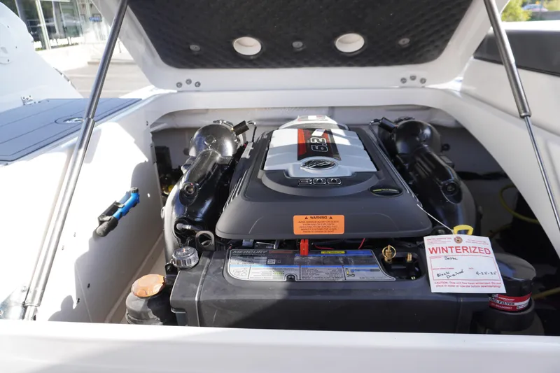 Slide: The Image of Engine compartment of 2026 Chaparral 247 SSX boat, featuring a powerful Mercury engine. - 35