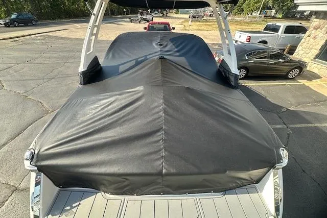 Slide: The Image of 2026 Chaparral 247 SSX boat with black cover in parking lot. - 39