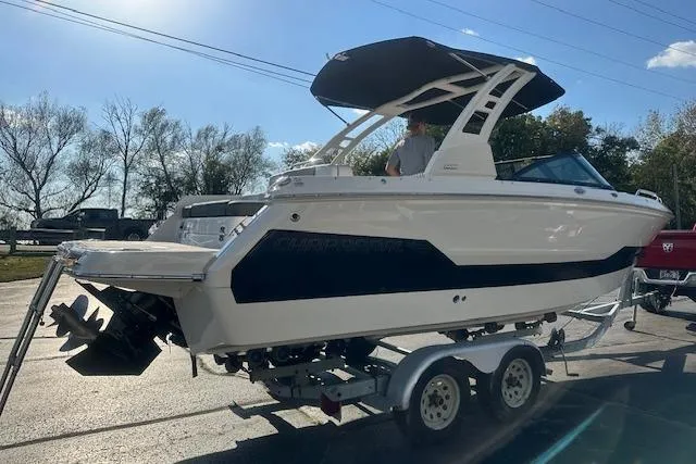 Slide: The Image of 2026 Chaparral 247 SSX boat on trailer, side view, outdoors, sunny day. - 4