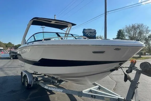 Slide: The Image of 2026 Chaparral 247 SSX boat on trailer, parked outdoors under clear sky. - 5
