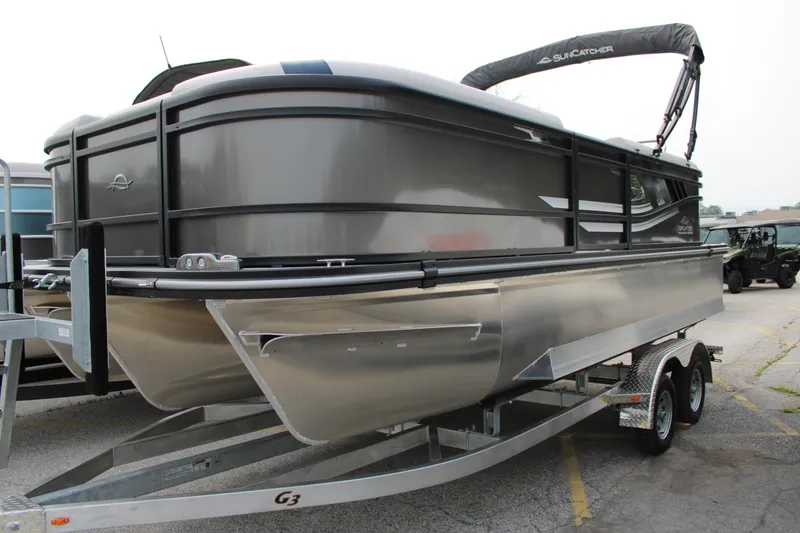 The Image of 2025 SunCatcher Select 320RCX pontoon boat on trailer, sleek design, parked outdoors. - 1