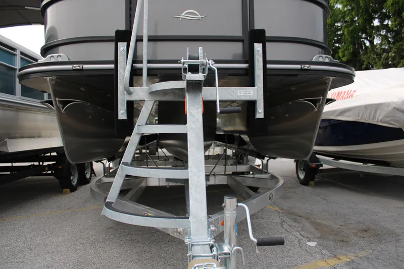 Slide: The Image of 2025 SunCatcher Select 320RCX pontoon boat on trailer, parked outdoors. - 14