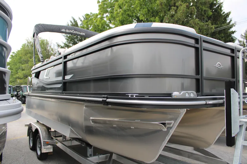 Slide: The Image of 2025 SunCatcher Select 320RCX pontoon boat on trailer, sleek design, outdoor setting. - 3