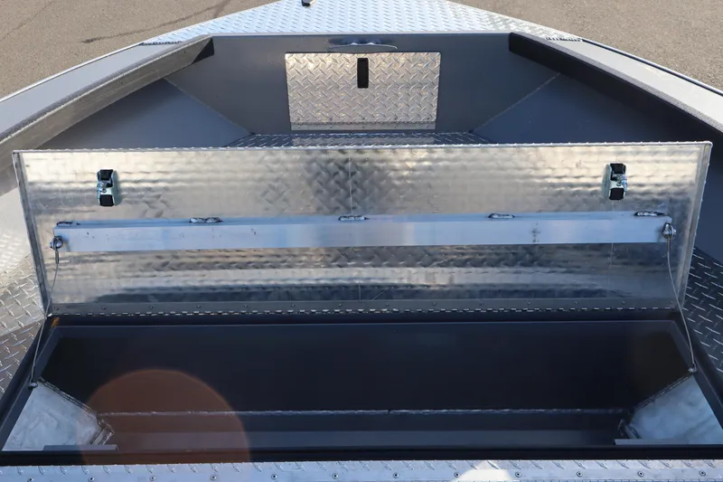Slide: The Image of Open storage compartment on 2026 Alumaweld Columbia 23 boat, featuring diamond plate design. - 12
