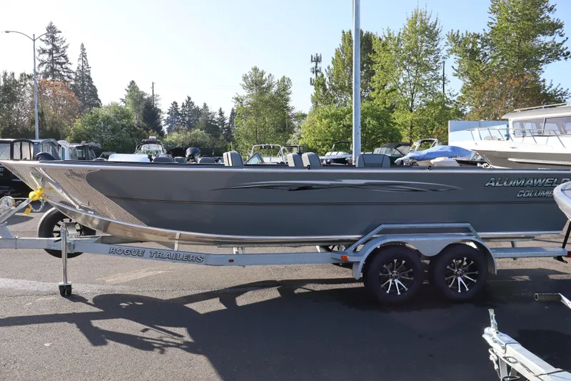 Slide: The Image of 2026 Alumaweld Columbia 23 boat on Rogue trailer, parked outdoors. - 3