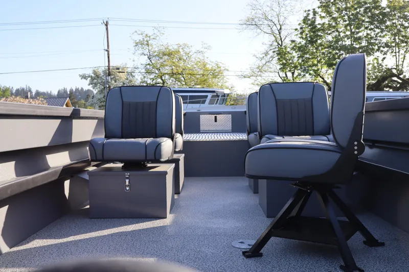Slide: The Image of 2026 Alumaweld Columbia 23 boat interior with two cushioned seats and storage compartments. - 5