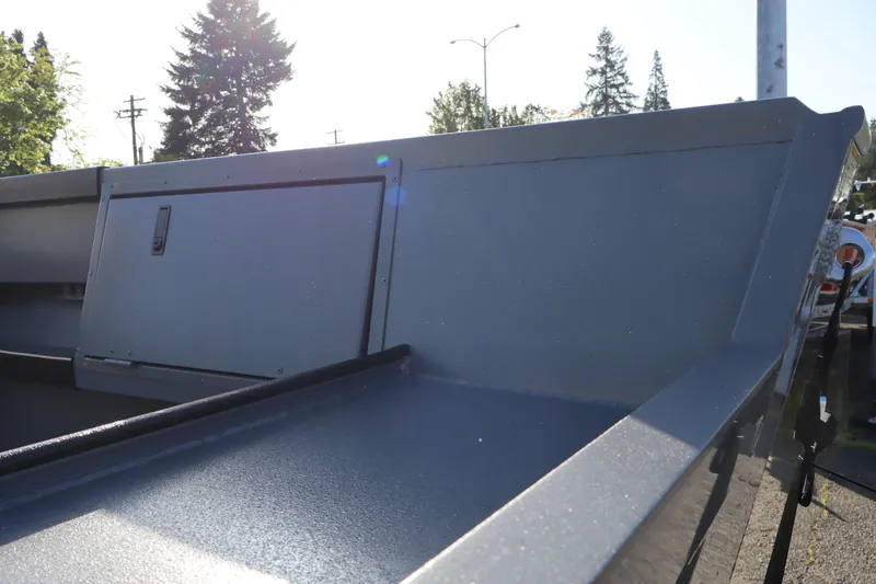 Slide: The Image of 2026 Alumaweld Columbia 23 boat interior with storage compartment, highlighted by sunlight. - 6