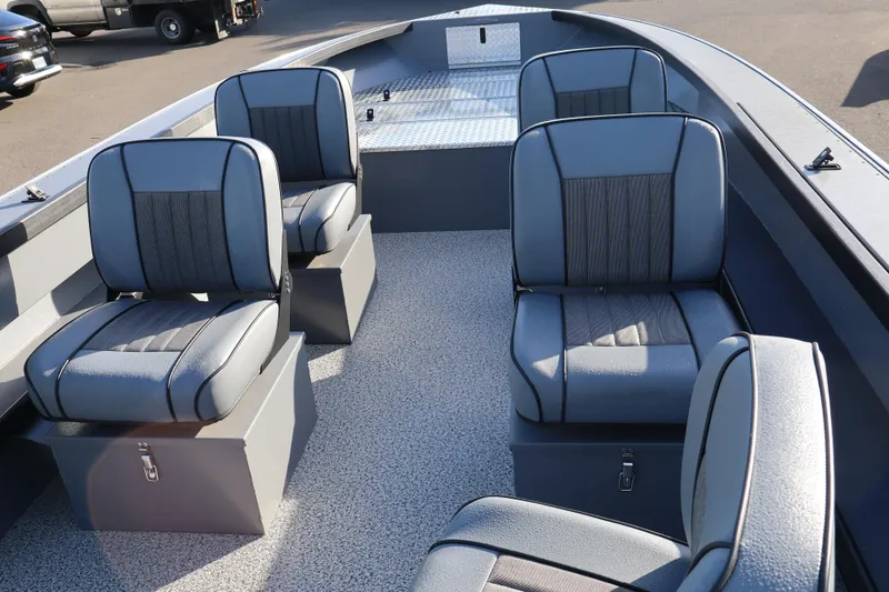 Slide: The Image of 2026 Alumaweld Columbia 23 boat interior with four cushioned seats and storage compartments. - 9