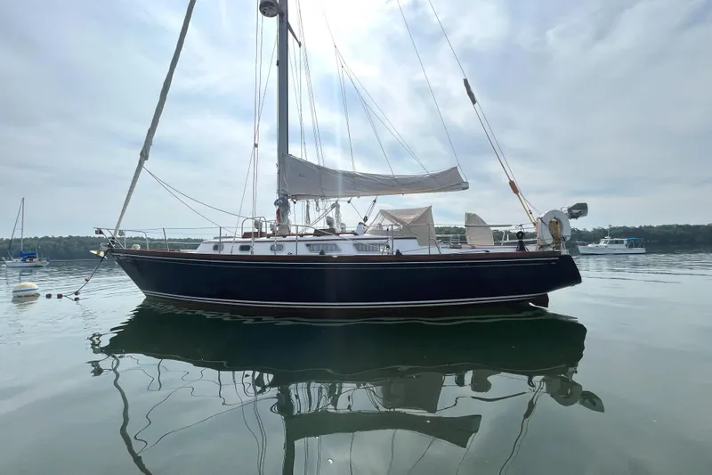 Slide: The Image of 1982 Bristol 38.8 sailboat on calm water. - 11