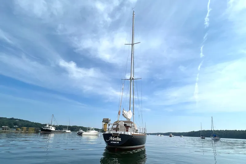 Slide: The Image of 1982 Bristol 38.8 sailboat on calm water under blue sky. - 21