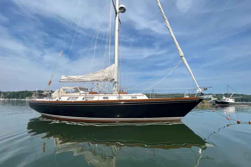 Slide: The Image of 1982 Bristol 38.8 sailboat on calm water under clear sky. - 24