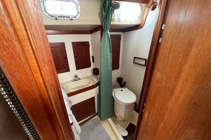 Slide: The Image of Interior view of a 1982 Bristol 38.8 boat bathroom with wood paneling. - 28