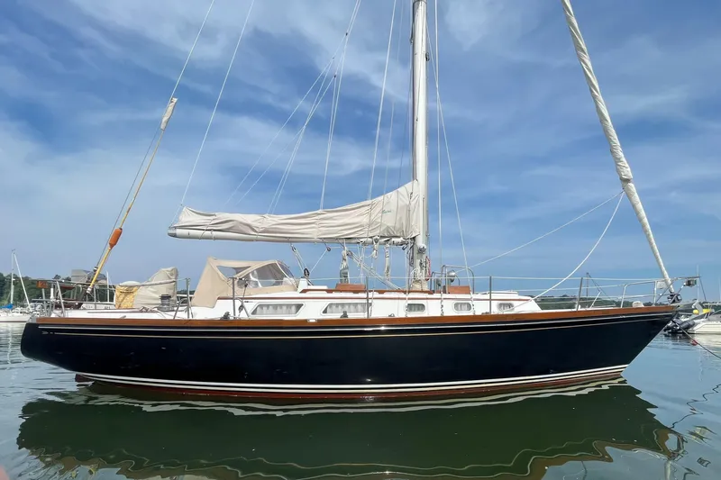 Slide: The Image of 1982 Bristol 38.8 sailboat on calm water under blue sky. - 3