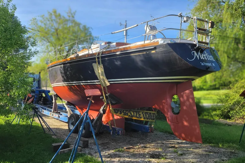 Slide: The Image of 1982 Bristol 38.8 sailboat on trailer in a green setting. - 45