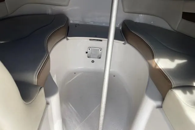 Slide: The Image of Interior seating of 2014 Chaparral 244 Sunesta boat, featuring cushioned benches. - 2