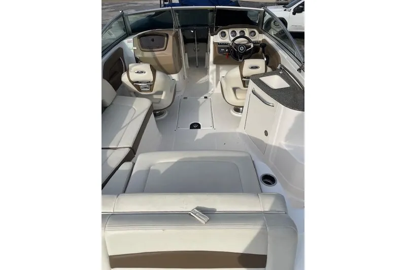 Slide: The Image of 2014 Chaparral 244 Sunesta boat interior with white seating and modern dashboard. - 3