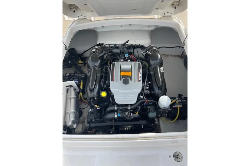 Slide: The Image of Engine compartment of a 2014 Chaparral 244 Sunesta boat, showcasing the engine layout. - 7