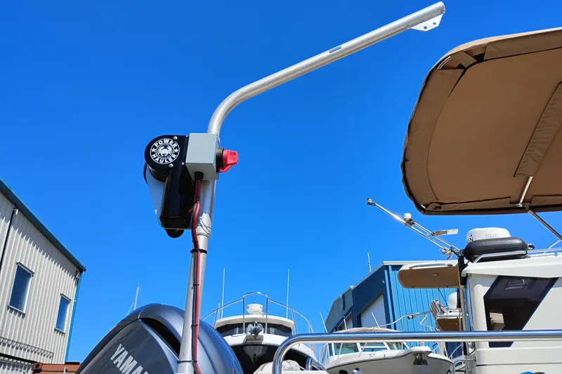 Slide: The Image of 2023 Ranger Tugs R-25 boat with Yamaha engine and tower, under clear blue sky. - 10