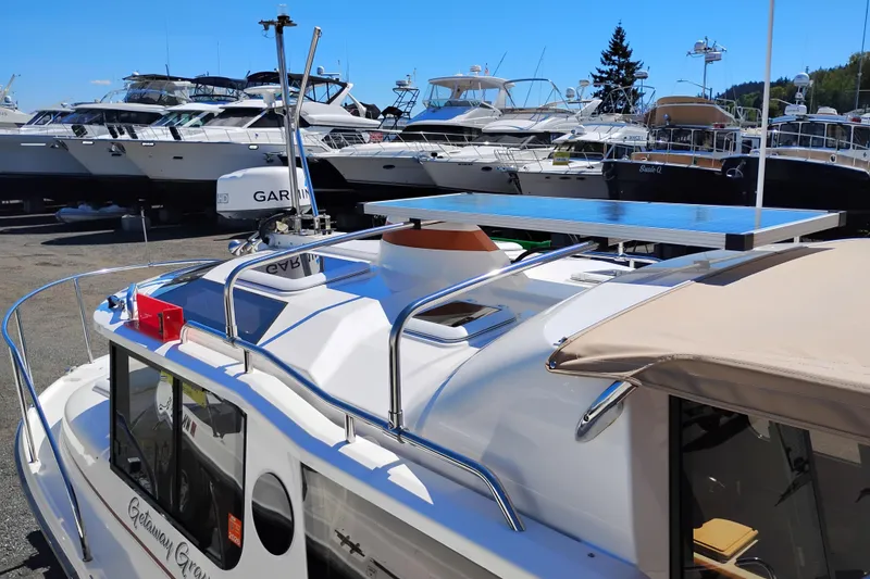Slide: The Image of 2023 Ranger Tugs R-25 boat with solar panel, docked among other vessels. - 17