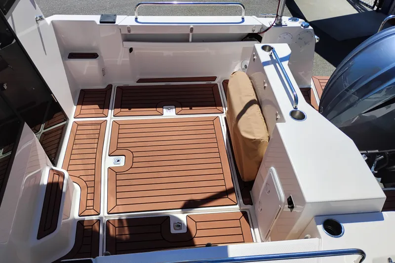 Slide: The Image of 2023 Ranger Tugs R-25 boat deck with teak flooring and modern design features. - 24