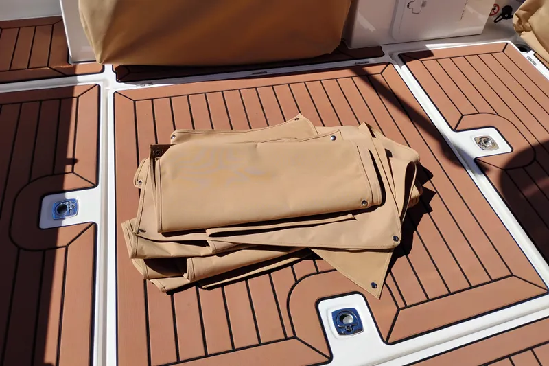 Slide: The Image of Folded tan canvas on 2023 Ranger Tugs R-25 boat deck. - 25
