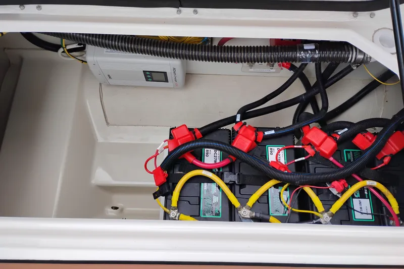 Slide: The Image of Battery compartment of 2023 Ranger Tugs R-25 with wiring and charger. - 27