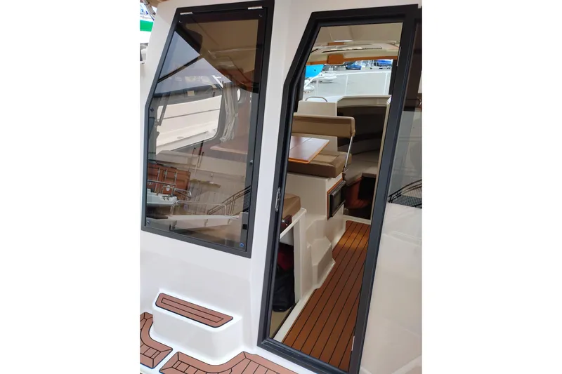 Slide: The Image of 2023 Ranger Tugs R-25 boat interior with sleek design and wooden flooring. - 33