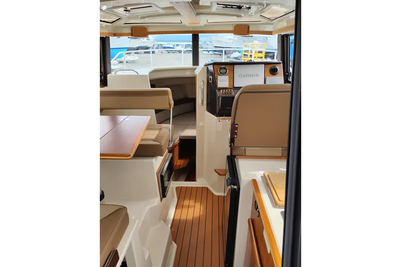 Slide: The Image of Interior of 2023 Ranger Tugs R-25 boat with modern helm and seating area. - 34
