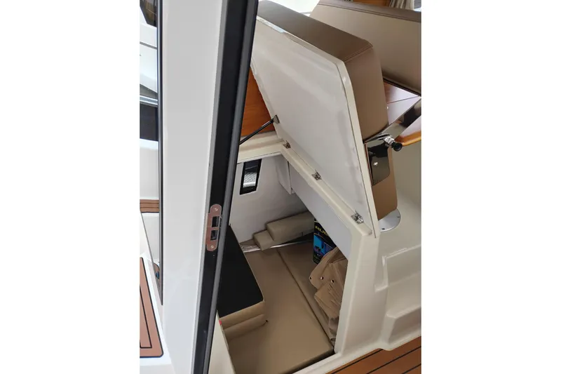 Slide: The Image of 2023 Ranger Tugs R-25 interior storage compartment with open seat hatch. - 36