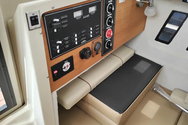 Slide: The Image of 2023 Ranger Tugs R-25 interior control panel with seating, showcasing modern design and functionality. - 38