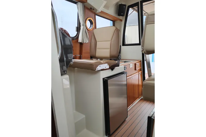 Slide: The Image of Interior of 2023 Ranger Tugs R-25 boat with seating and compact kitchen area. - 45