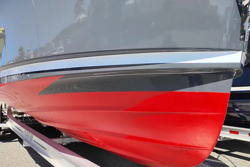 Slide: The Image of 2023 Ranger Tugs R-25 boat with sleek red and gray hull design. - 5
