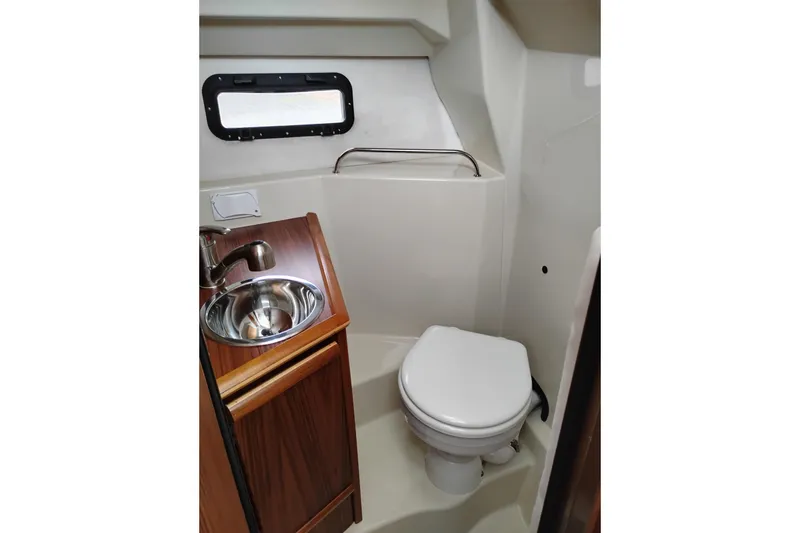 Slide: The Image of Compact bathroom in 2023 Ranger Tugs R-25 boat with sink and toilet. - 55