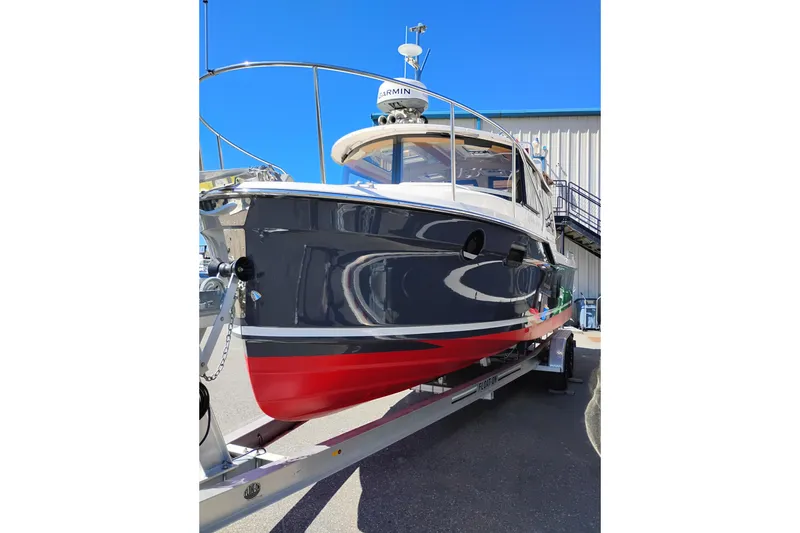 Slide: The Image of 2023 Ranger Tugs R-25 boat on trailer, featuring sleek design and vibrant colors. - 6
