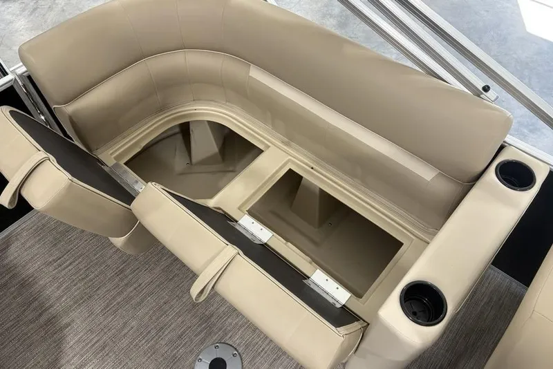 Slide: The Image of 2026 Godfrey XPERIENCE 2086 boat interior with beige seating and storage compartments. - 7
