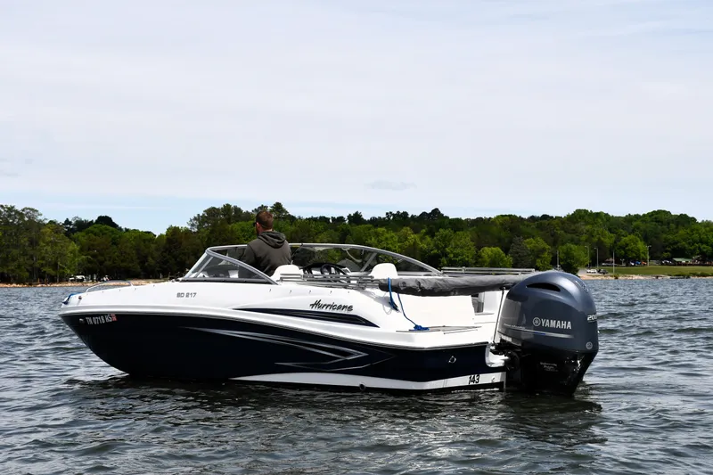 The Image of 2023 Hurricane SunDeck 217 OB boat on a lake with Yamaha outboard motor. - 0