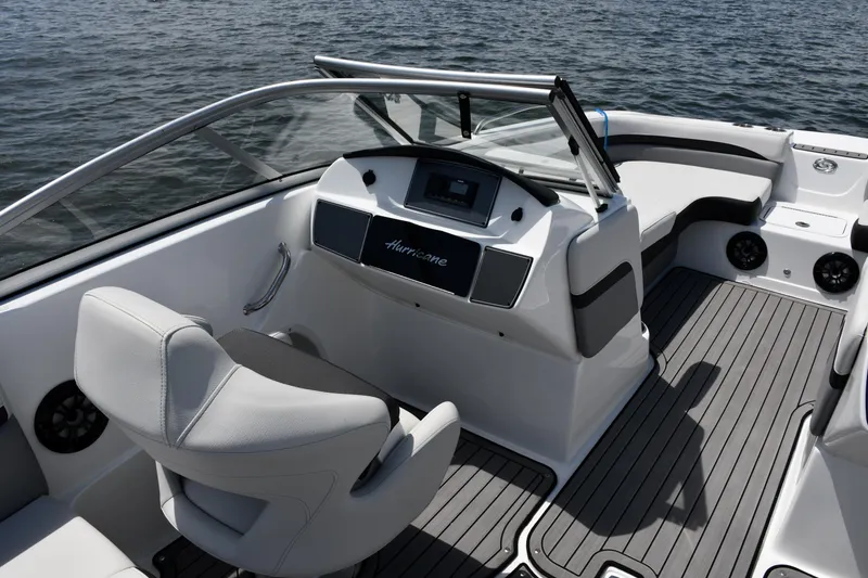 Slide: The Image of 2023 Hurricane SunDeck 217 OB boat interior with sleek seating and modern dashboard design. - 11