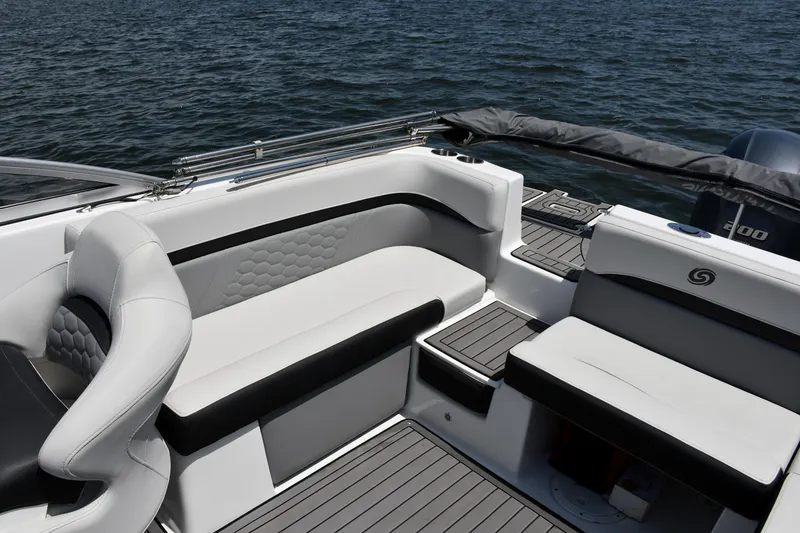 Slide: The Image of 2023 Hurricane SunDeck 217 OB boat interior with sleek seating and modern design on the water. - 12