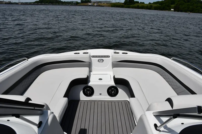 Slide: The Image of 2023 Hurricane SunDeck 217 OB boat interior with spacious seating on calm water. - 4