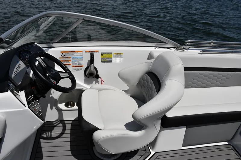 Slide: The Image of 2023 Hurricane SunDeck 217 OB boat interior with steering wheel and comfortable seating. - 9