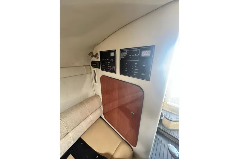 Slide: The Image of Interior view of a 2006 Monterey 270 Cruiser boat with control panel and seating. - 13