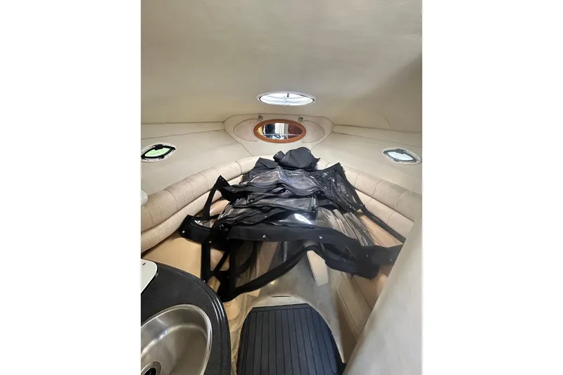 Slide: The Image of Interior cabin of a 2006 Monterey 270 Cruiser with seating and portholes. - 14