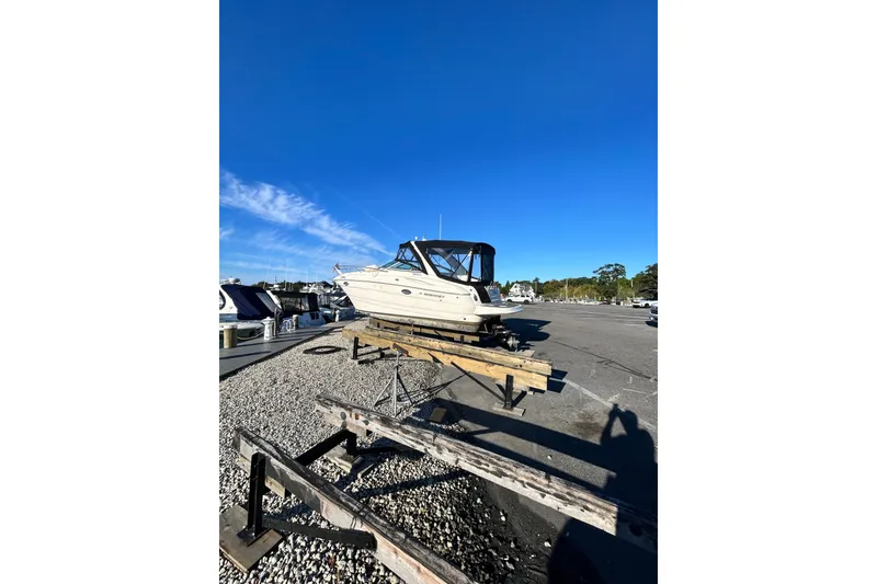 Slide: The Image of 2006 Monterey 270 Cruiser boat on dry dock under clear blue sky. - 18