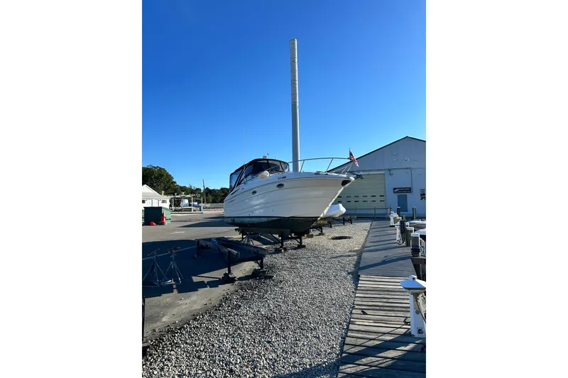 Slide: The Image of 2006 Monterey 270 Cruiser boat on dry dock, clear blue sky background. - 19
