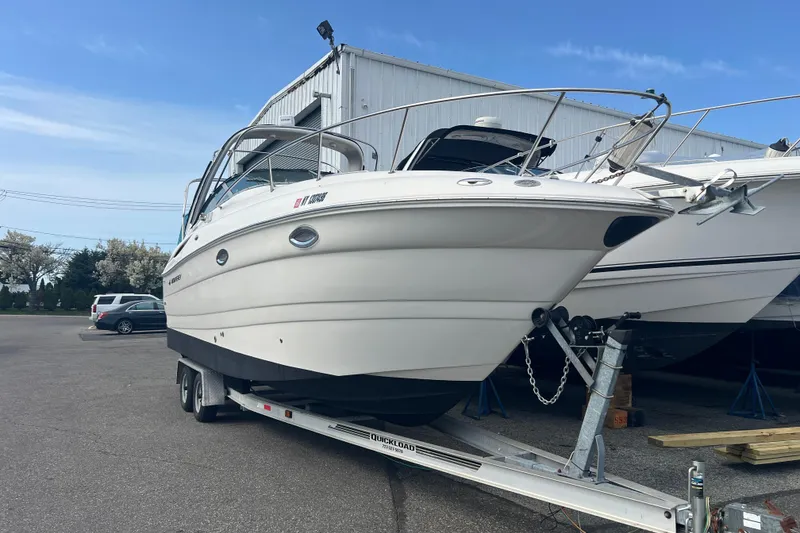 Slide: The Image of 2006 Monterey 270 Cruiser boat on trailer, parked outdoors under clear blue sky. - 20