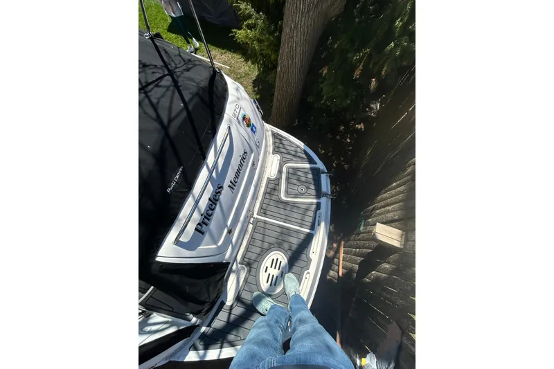 Slide: The Image of Person standing on 2006 Monterey 270 Cruiser boat deck, labeled "Priceless Memories." - 24