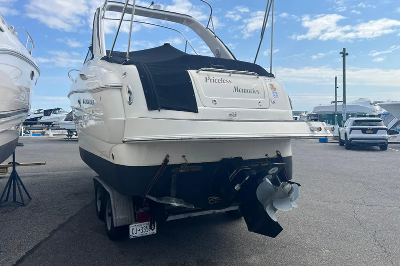 Slide: The Image of 2006 Monterey 270 Cruiser boat on trailer at marina, labeled "Priceless Memories." - 26